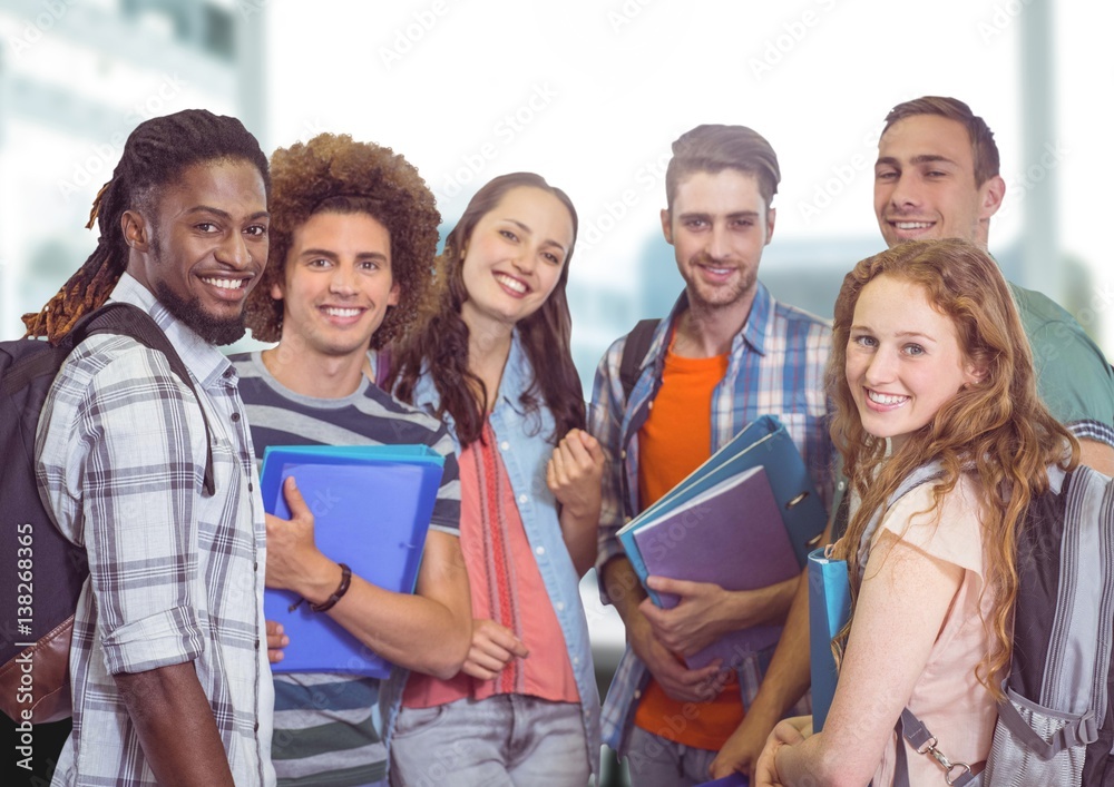 Students group smiling at camera against a light background