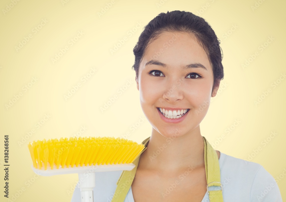 Happy Cleaner lady smiling at camera against a yellow background