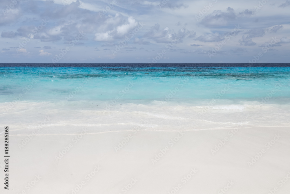 White beach sand and beautiful blue sea and sky