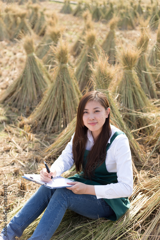 young asian woman in golden cereal field