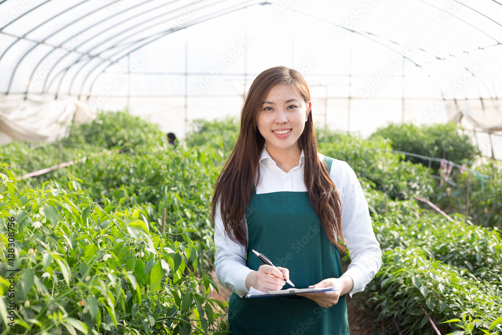 young asian woman working in green house