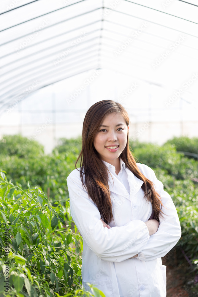 young asian woman working in green house