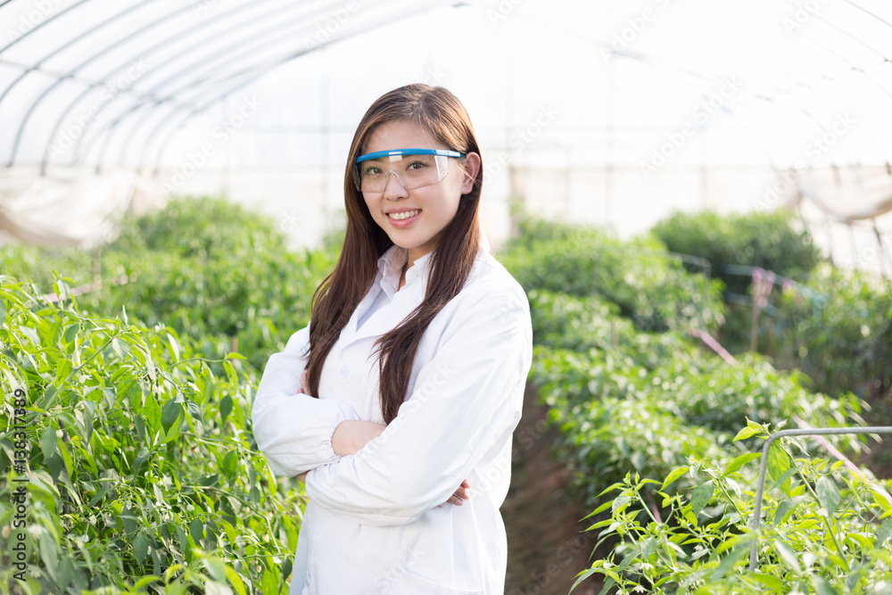 young asian woman working in green house