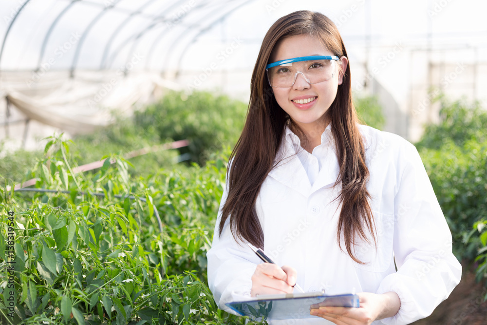 young asian woman working in green house