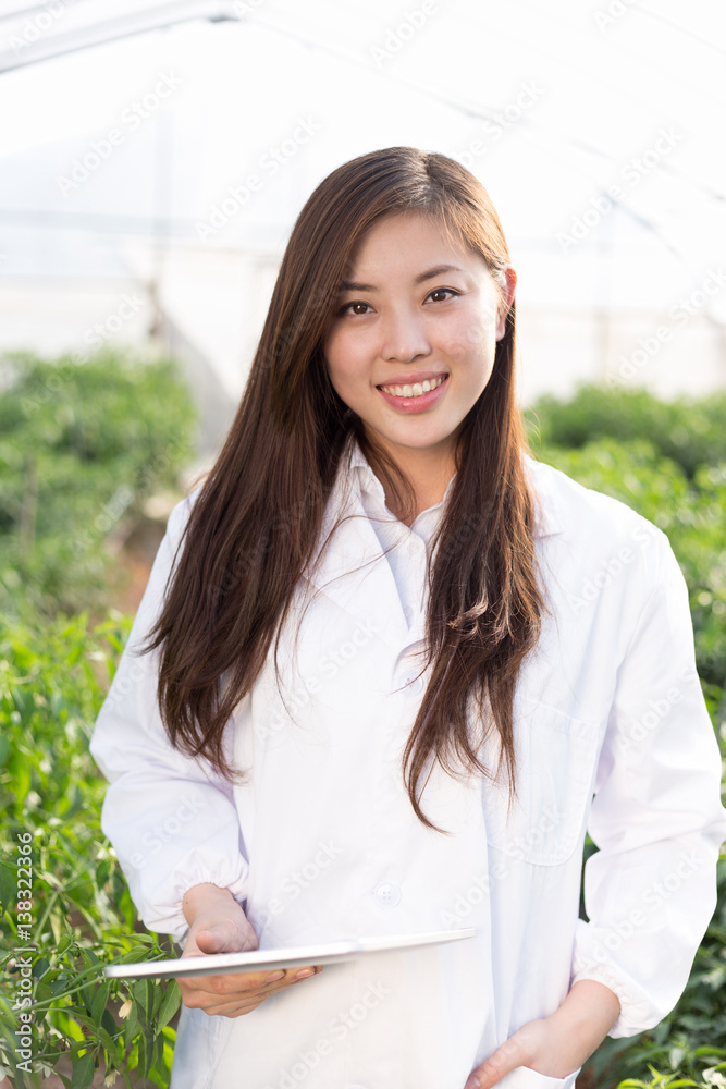 young asian woman working in green house