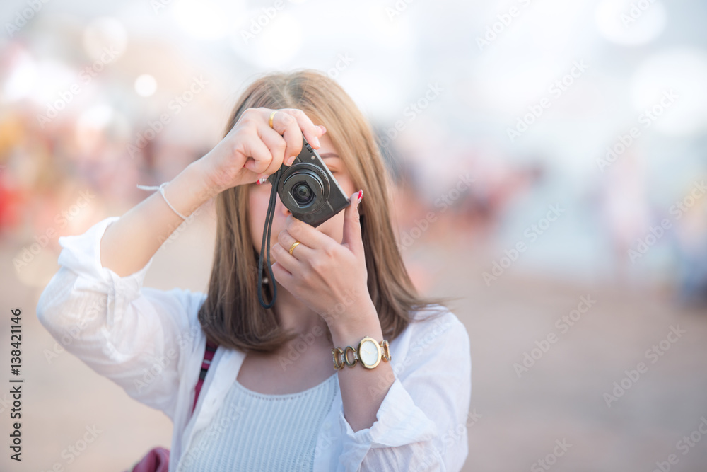 traveler beautiful girl with camera on the beach take photo like photographs