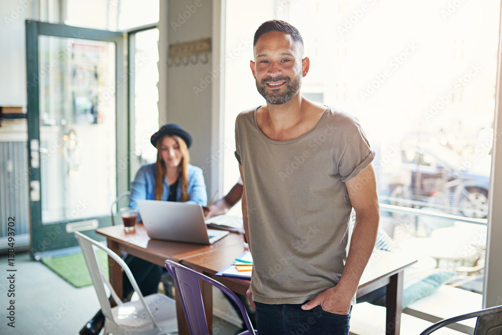 Young male smiling at camera at workplace