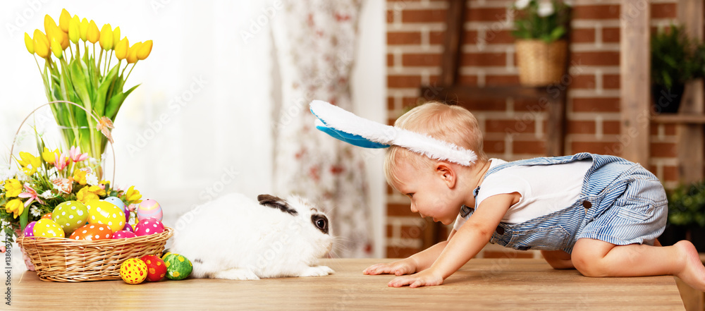 happy easter! happy funny baby boy playing with bunny