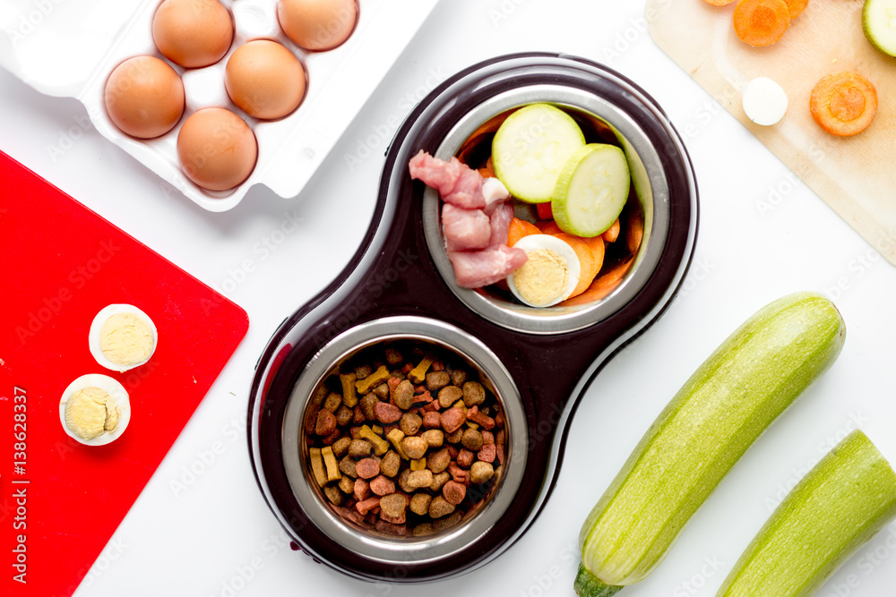 petfood set with vegetables and eggs on kitchen table background top view