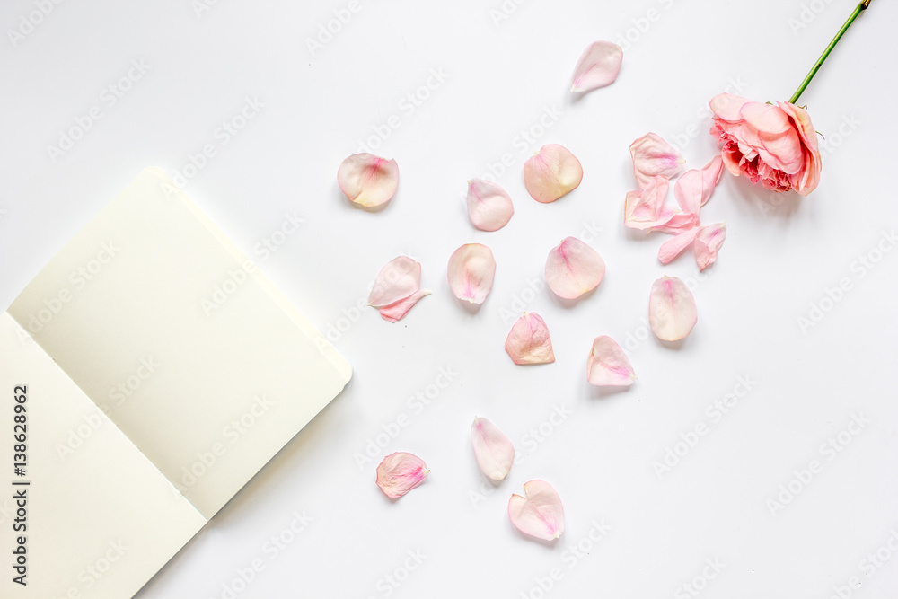 trandy design with flower and copybook on white background top veiw mock-up