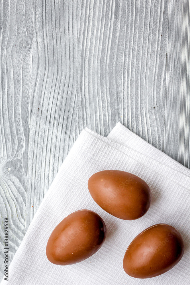 Easter chocolate eggs top view on wooden background mock up