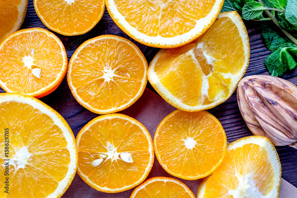 Orange juice making from fruit and mint on kitchen table top view