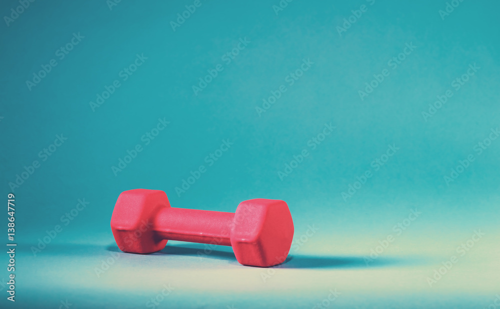 Pink dumbbell on a blue background