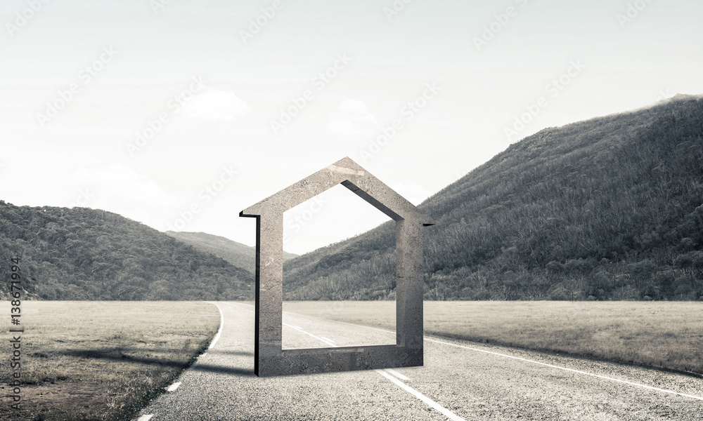 Conceptual background image of concrete home sign on asphalt roa