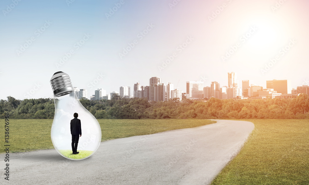 Businessman inside light bulb