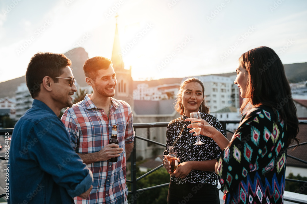 Young men and women having a rooftop party