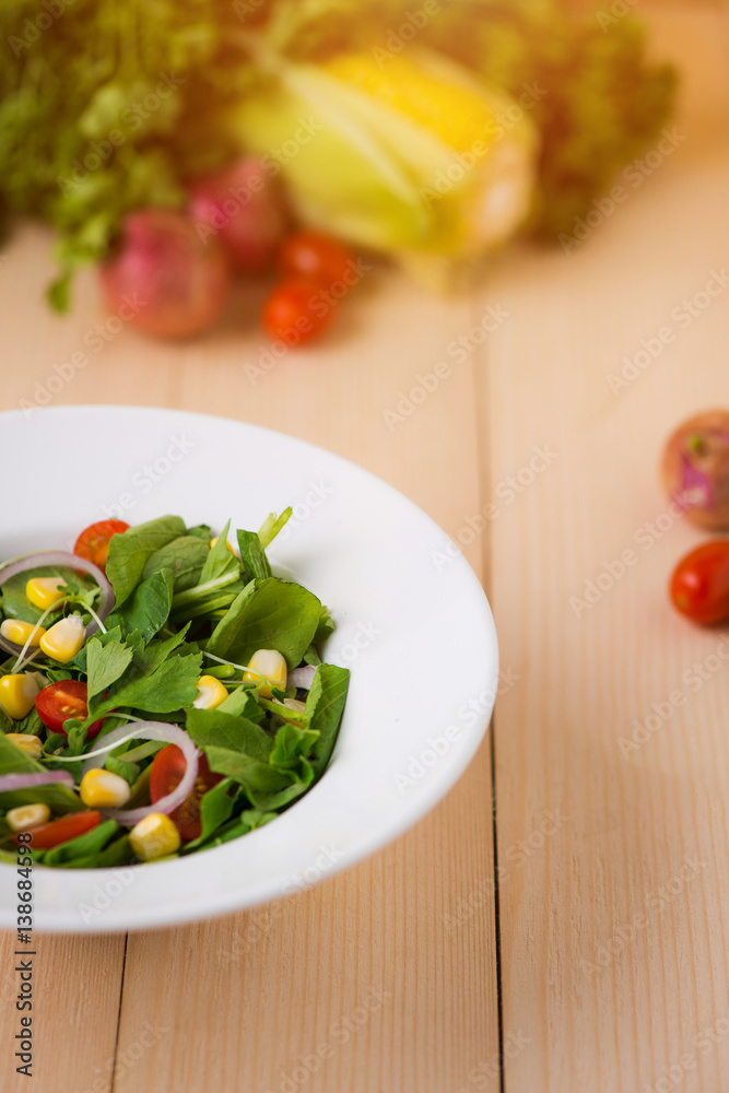 Homemade fresh green vegetable salad on table.