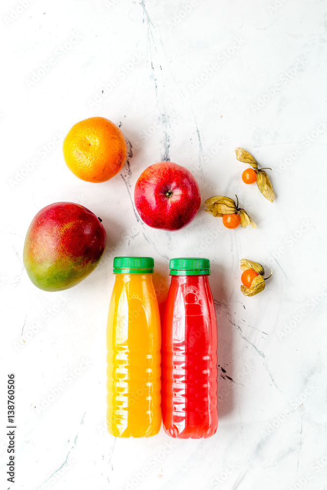 bottles of smoothie with fruits on white table top view mock up