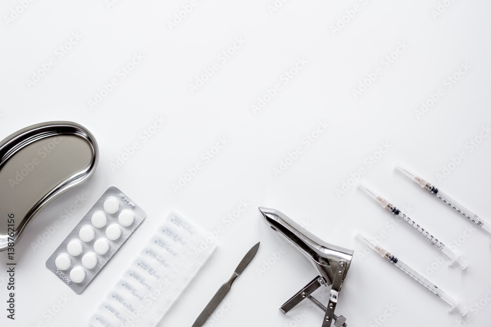 instruments of gynecologist on white background top view mock up