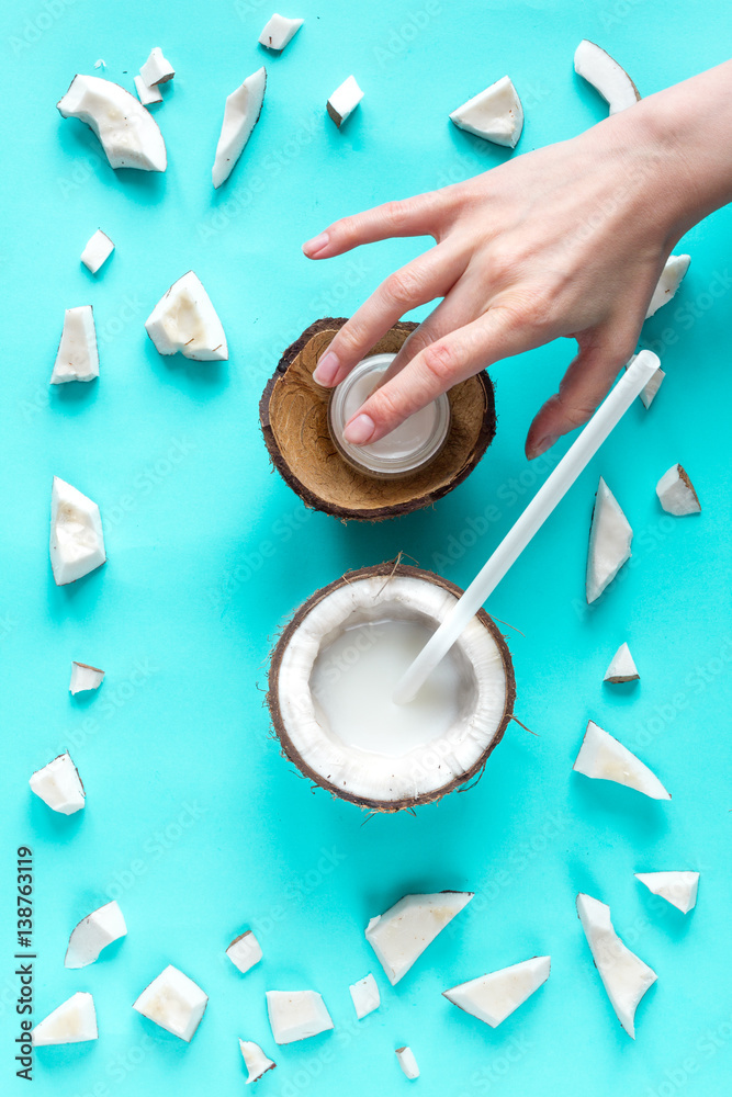 concept organic cosmetics with coconut on blue background top view