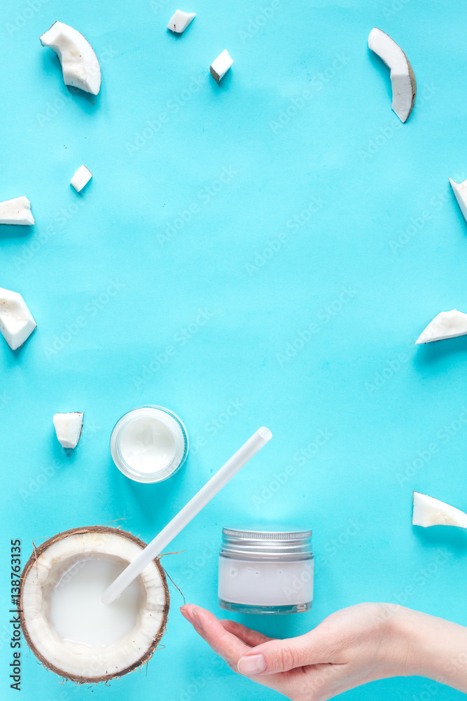 concept organic cosmetics with coconut on blue background top view