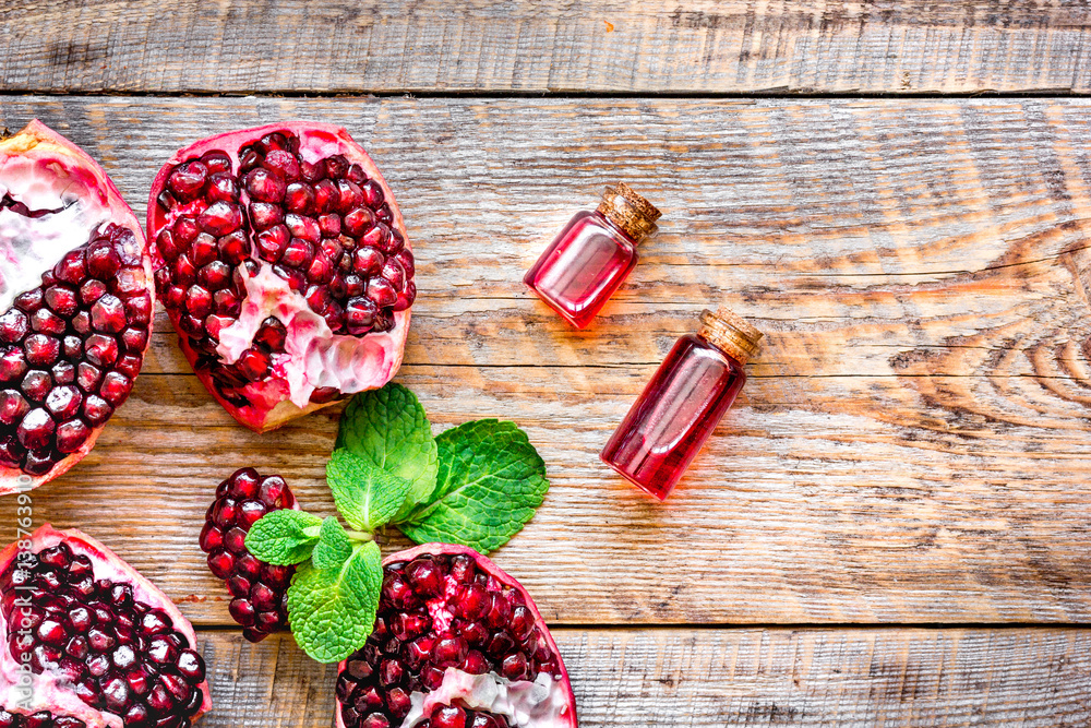 sliced pomegranate on wooden background top view