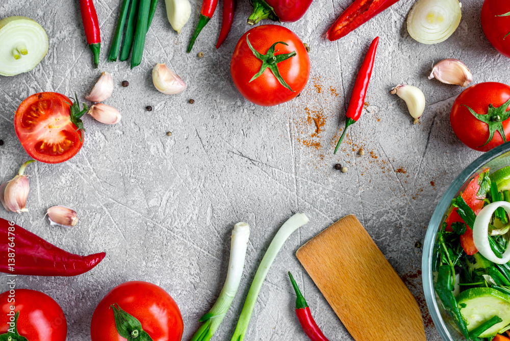 cooking vegetables on the stone background top view