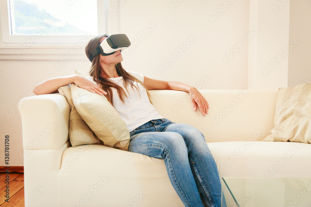 Young Woman Sitting On Couch, Using Vr Glasses