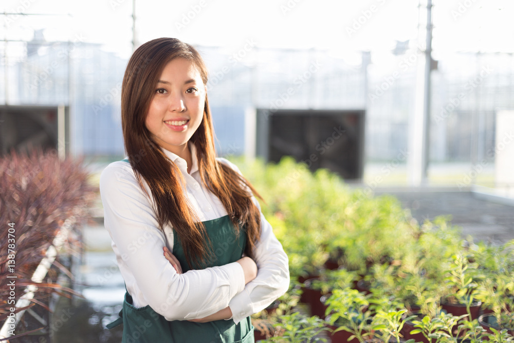 young beautiful asian woman works in green field