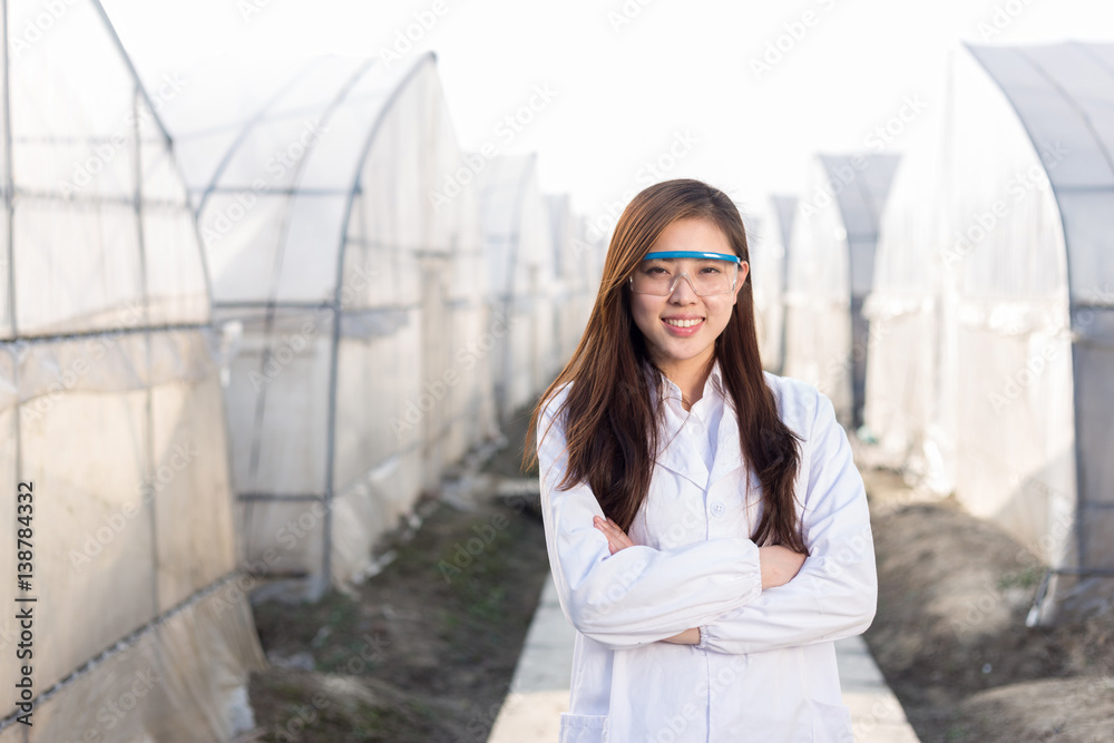 young beautiful asian woman works in green field