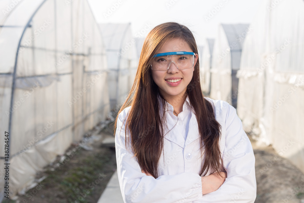 young beautiful asian woman works in green field