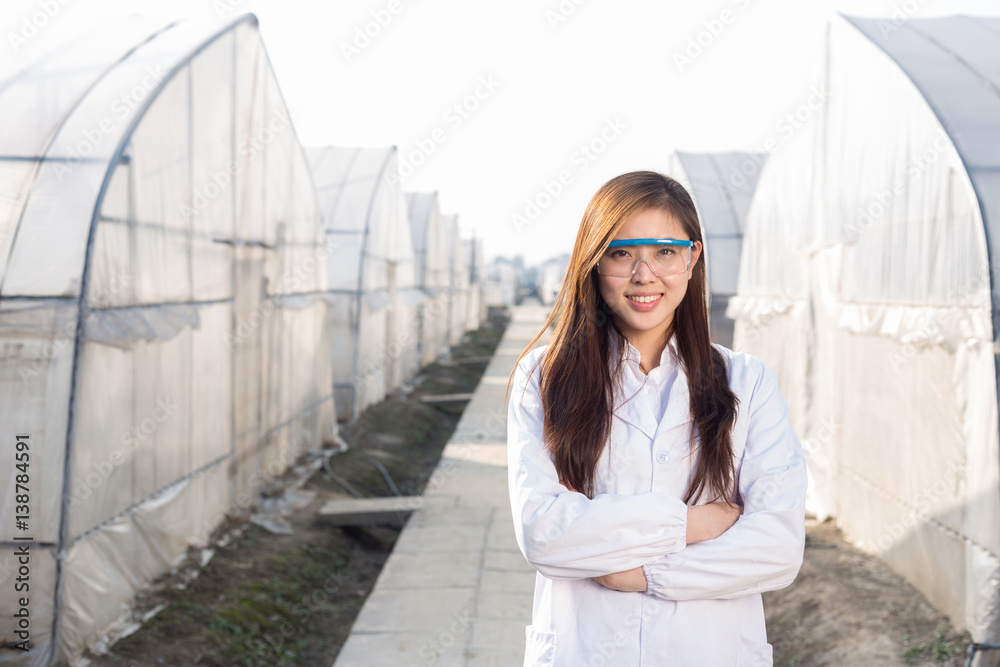 young beautiful asian woman works in green field