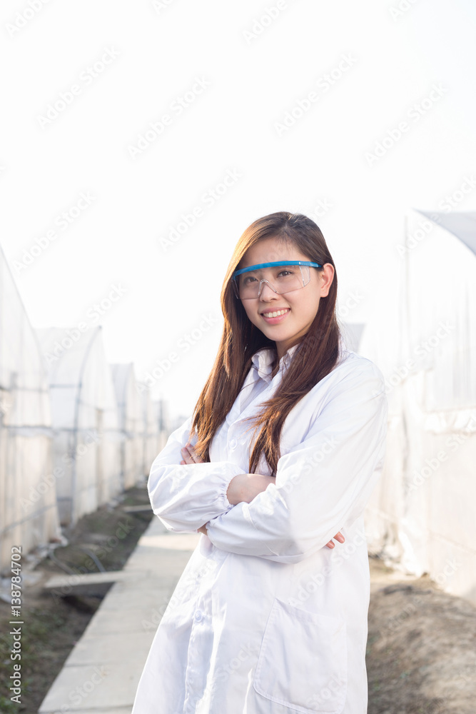 young beautiful asian woman works in green field