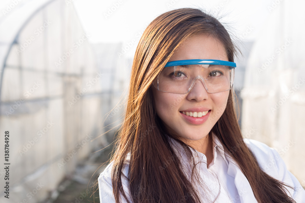 young beautiful asian woman works in green field