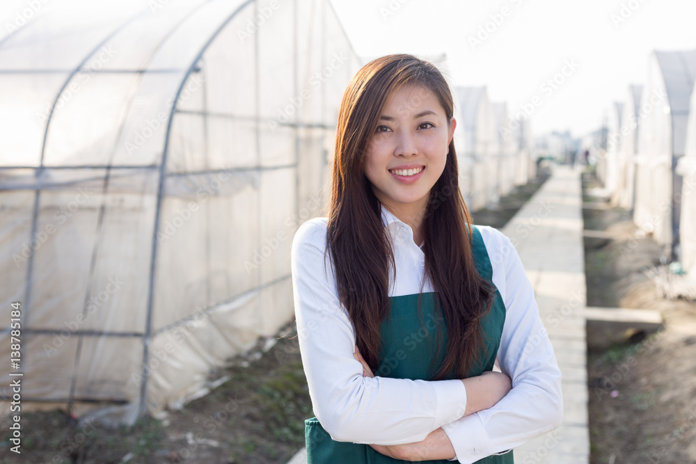 young beautiful asian woman works in green field