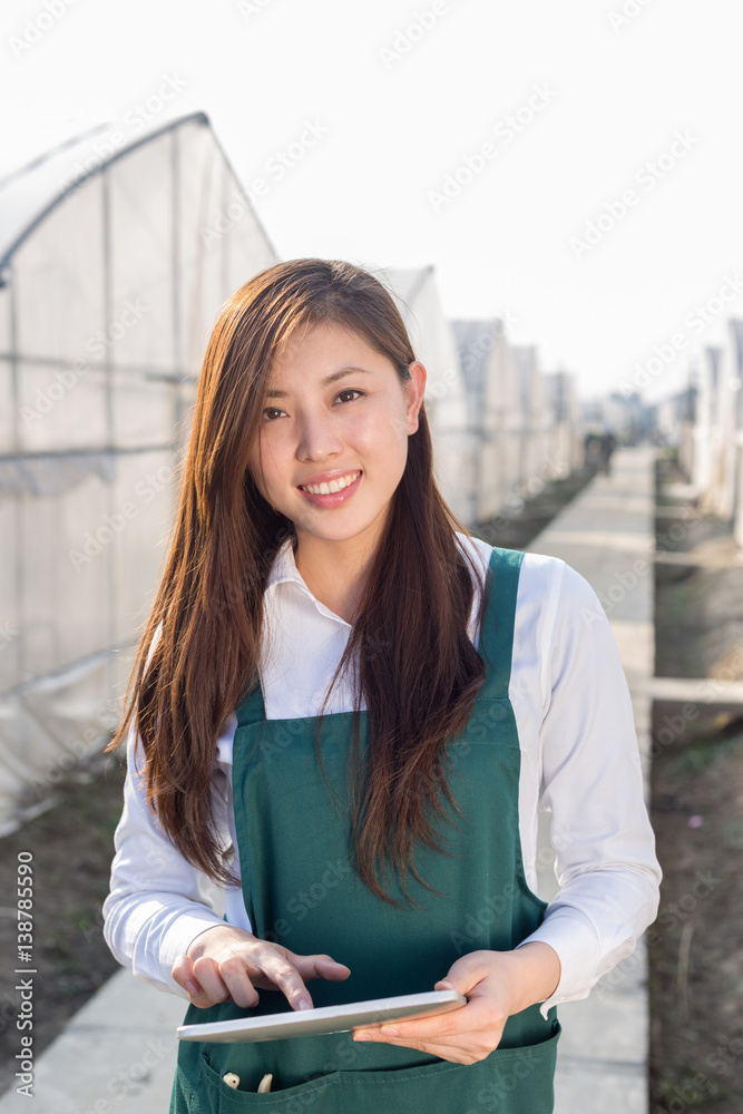 young beautiful asian woman works in green field