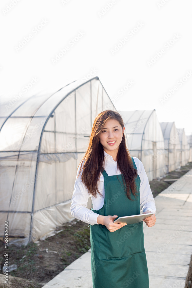 young beautiful asian woman works in green field