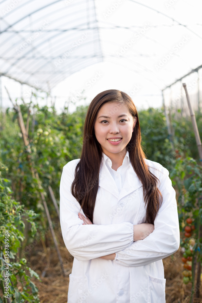 young beautiful asian woman works in green field