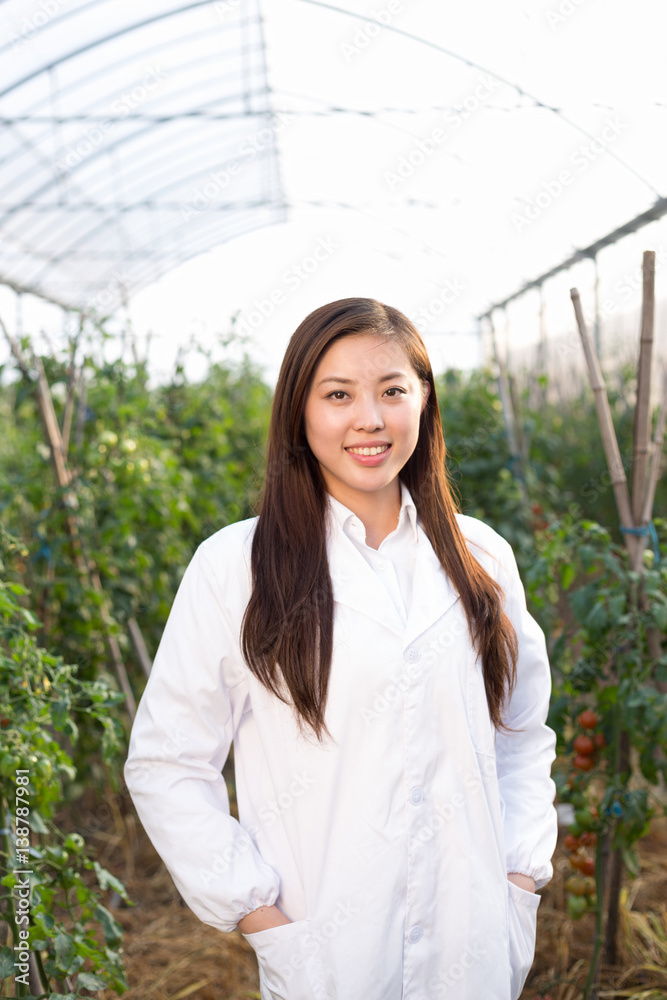 young beautiful asian woman works in green field