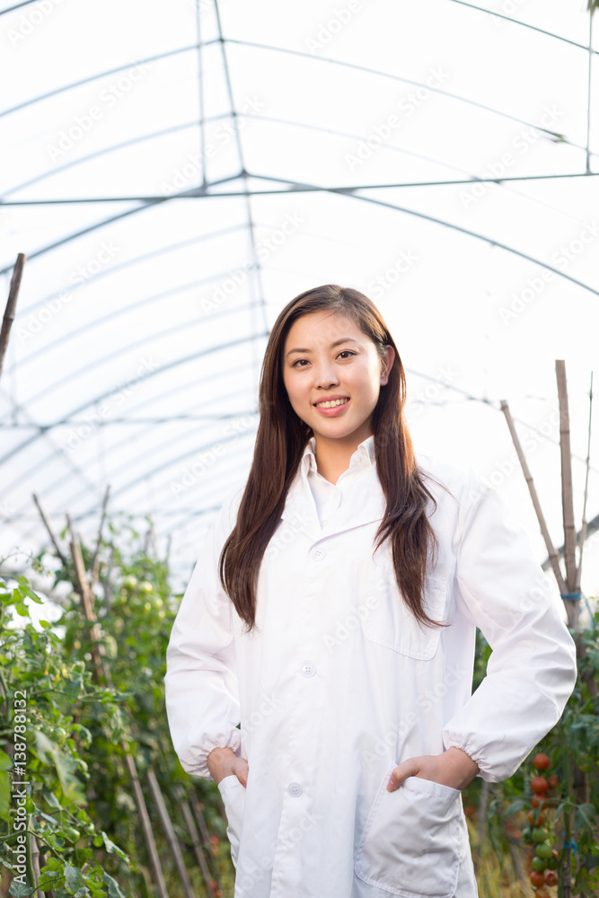 young beautiful asian woman works in green field