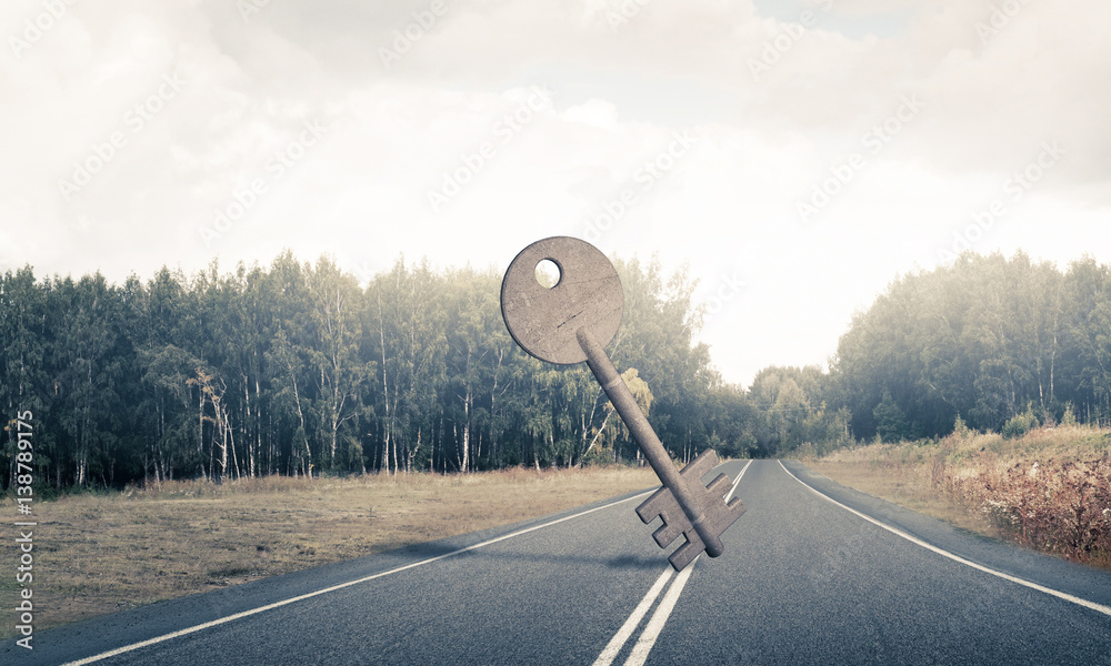 Conceptual background image of concrete key sign on asphalt road