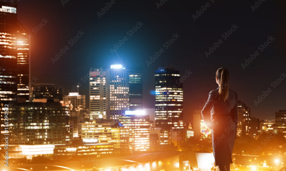 Woman looking at night city