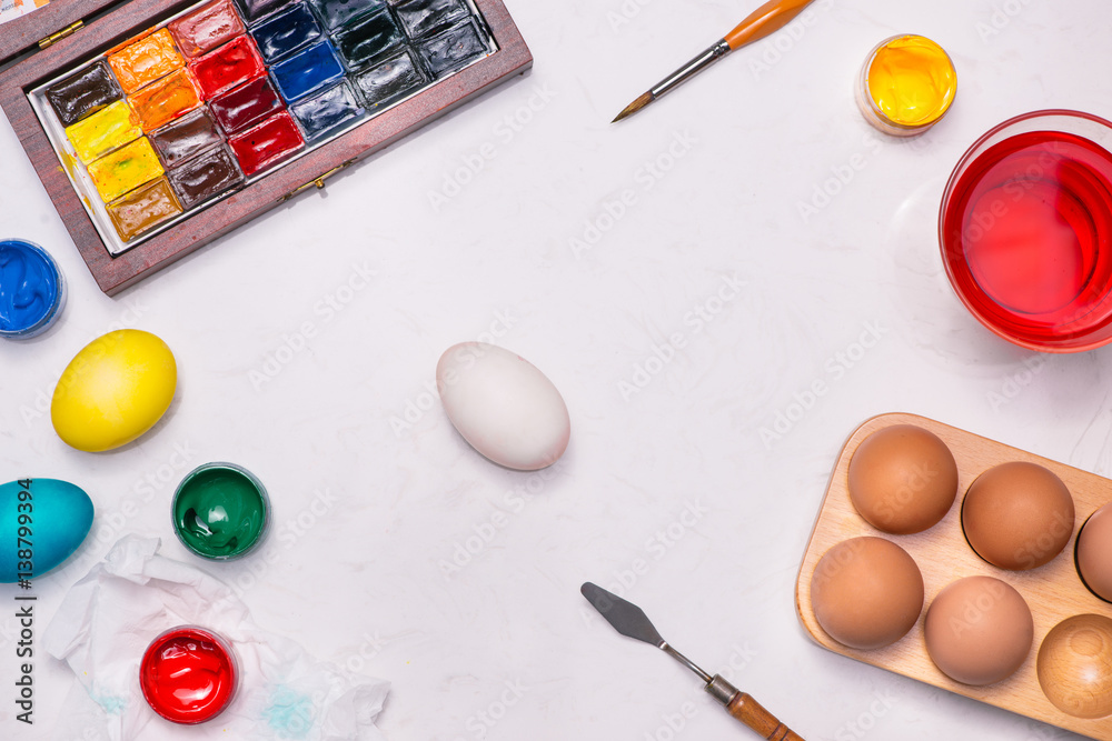 Happy Easter! Friends painting Easter eggs on table.