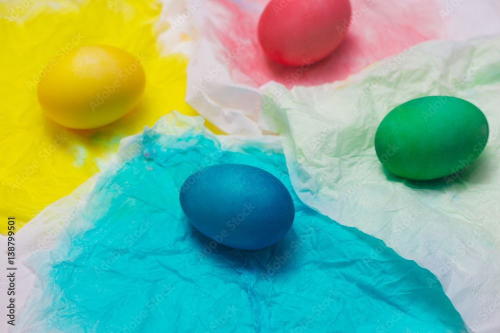 Happy Easter! Painting colorful easter eggs on table.