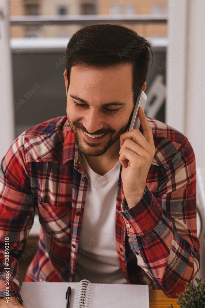 Handsome young businessman using cellphone