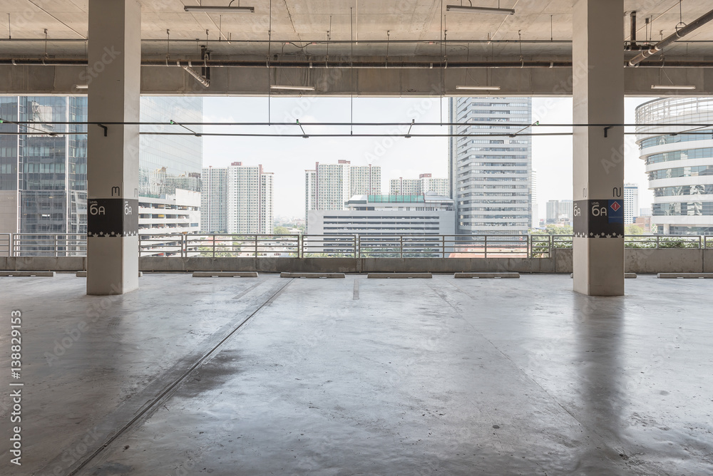 interior of parking garage with car and vacant parking lot