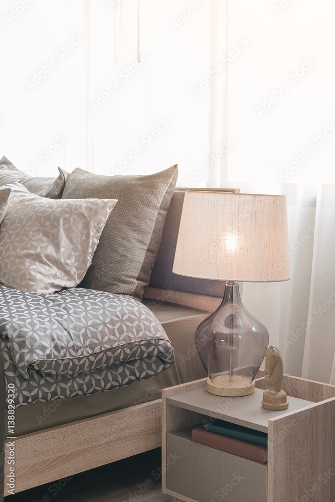 classic lamp style with alarm clock on table side in cozy bedroom