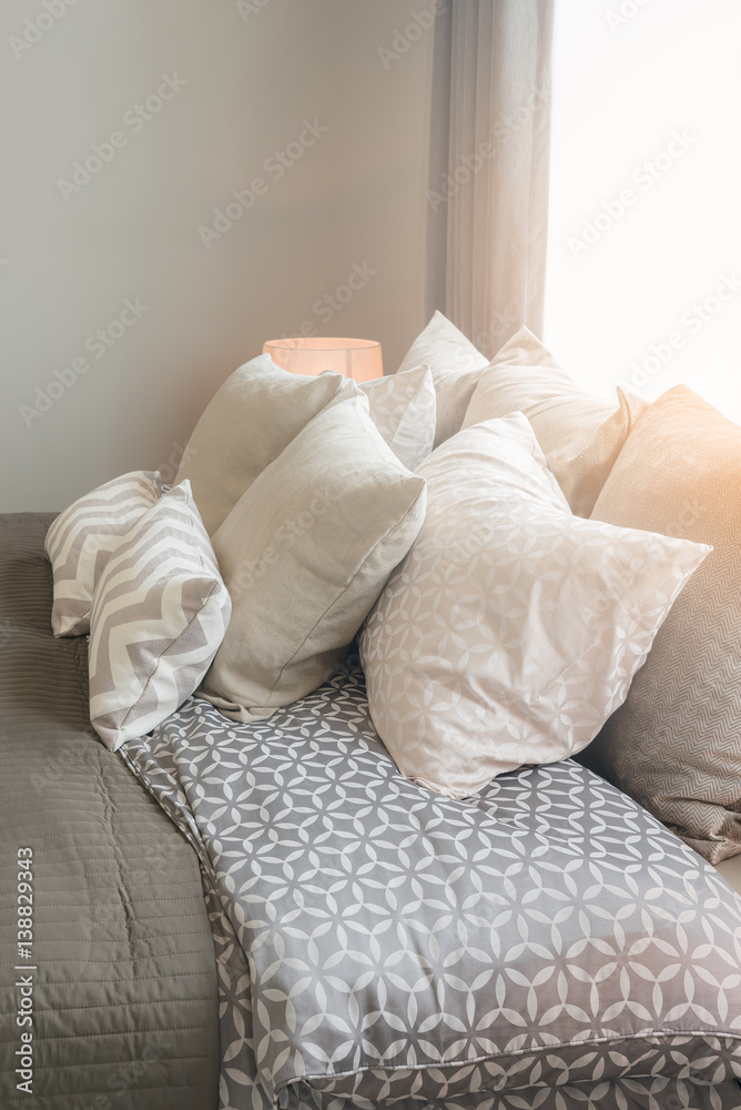 set of pillows on bed in cozy bedroom