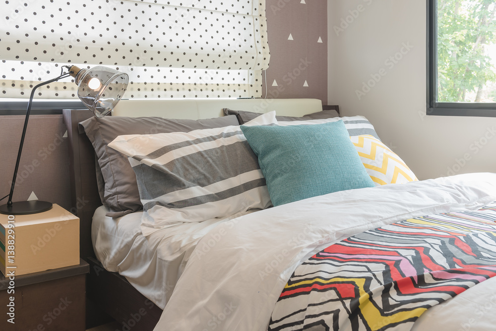 colorful pillows set on bed in modern bedroom