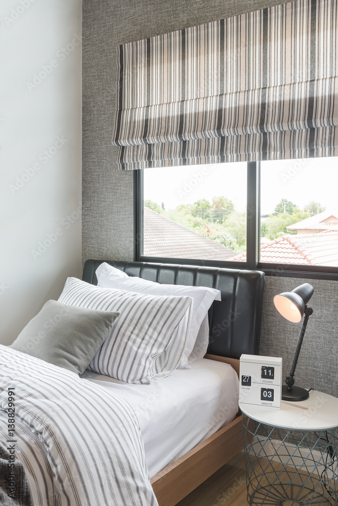 set of pillows with blanket on modern wooden bed